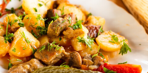 dish of baked potatoes with beef stew with herbs