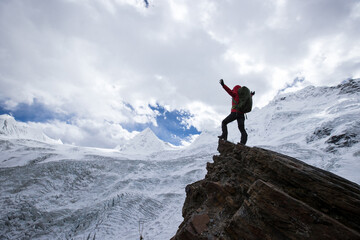 Woman hiker hiking  in winter mountains