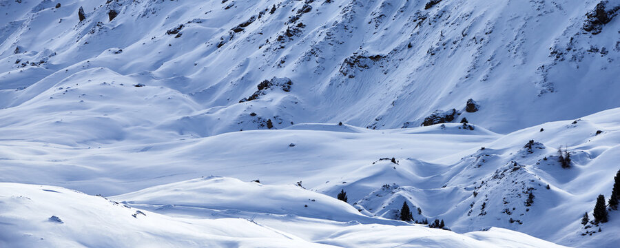 Panoramic view of the snow-covered mountain slope at the Tignes ski resort in France during the winter season.