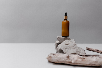 Skin and body care concept. Trendy grey background with textured rocks and cosmetics. Top horizontal view copyspace