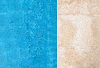 Fototapeta premium View from above at a swimming pool edge with blue water outdoors. Closeup horizontal photo