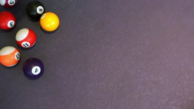 Top view playing the pool-billiard game on purple baize table