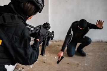 Man reenacting special unit of Croatian military police. Wearing green jumpsuit with black add-ons and assault rifle G36.