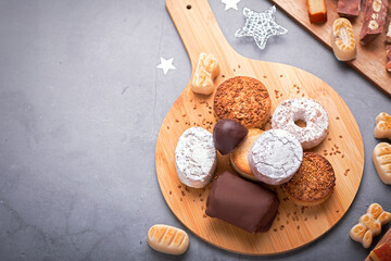 Traditional Spanish Christmas sweets turron, polvorones, mantecados with Christmas decor on grey table top, copy space