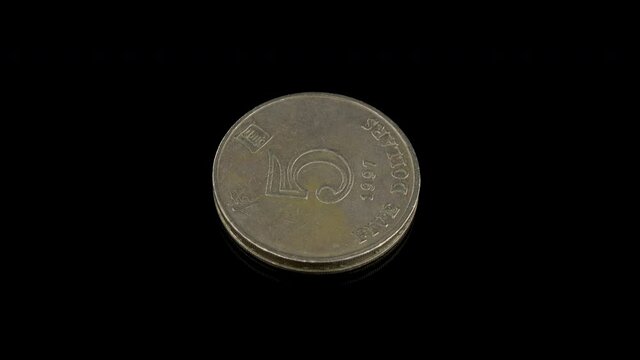 Hong Kong 5 dollars coin from 1997 on a black background