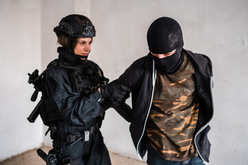 Man reenacting special unit of Croatian military police. Wearing green jumpsuit with black add-ons and assault rifle G36.