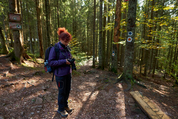 Fototapeta premium Tourist lady with camera hiking