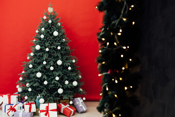 New Year's Red Christmas Tree decor with gifts and garlands interior
