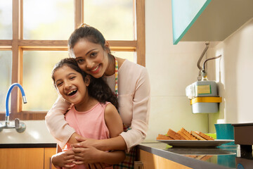 Portrait of a mother and daughter in the kitchen	