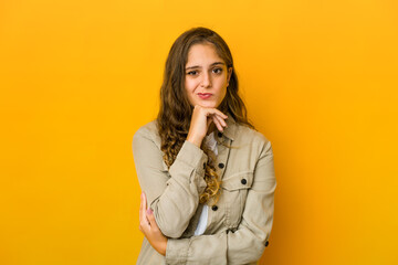 Young caucasian woman suspicious, uncertain, examining you.