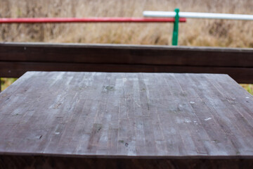 wooden table in autumn rainy forest