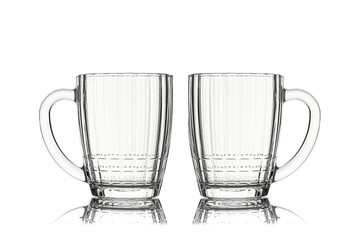 Two empty glass beer mugs isolated on white background with reflection
