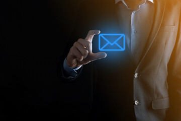 Businessman hand holding e-mail icon, Contact us by newsletter email and protect your personal information from spam mail. Customer service call center contact us concept