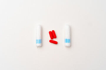 Female medical tampons and painkiller pills top view