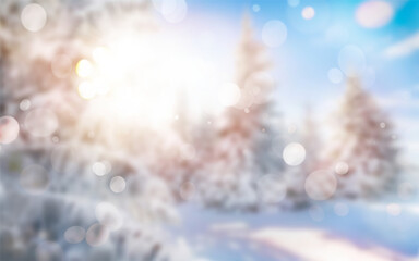A blurred abstract Christmas winter landscape scene with sunlight bokeh through a background of...
