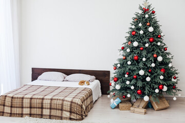 New year bedroom decor with Christmas tree bed with gifts and garlands interior