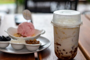 Pearl milk tea with ice cream on a wooden table