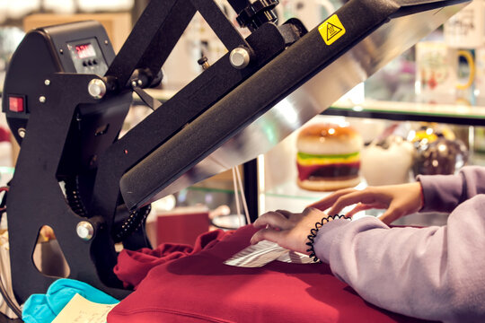 Textile print industry. Man preparing t-short for a print