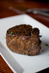 Steak. Grass-fed skirt steak, grilled to a medium rare and served with a garlic herb butter sauce and paired with roasted potatoes and Brussels sprouts. Classic American steakhouse favorite.