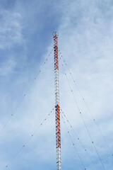 Radio communication antenna mast with guy-wires.