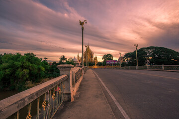 Fototapeta na wymiar The background of religious attractions in Phitsanulok Province (Wat Chan Tawan Tok) has a distinctive golden yellow sculpture, close to the Nan River, tourists always come to make merit in Thailand