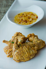 Deep fried quail legs served with spicy horseradish dipping sauce. Classic American steakhouse or French bistro main course favorite.  Beer battered cast iron skilled fried quail legs.