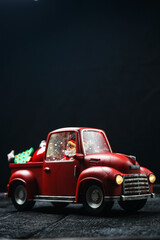 christmas mock-up souvenir red car with santa driving on a black background vertical photo
