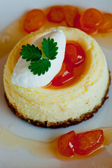 Cheesecake with candied oranges and vanilla ice cream. Classic dessert. Lady fingers soaked in syrup, espresso and layered with cream, nuts and powdered sugar.