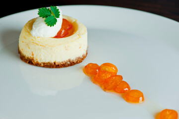 Cheesecake with candied oranges and vanilla ice cream. Classic dessert. Lady fingers soaked in syrup, espresso and layered with cream, nuts and powdered sugar.