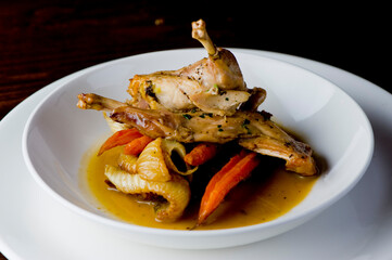 Chicken pan seared in garlic, butter, shallots and white wine. Classic fine dining cuisine. Served with steamed vegetables, broccoli carrots cauliflower, garnished with lemons and Italian parsley.