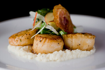 Scallops sautéed in olive oil, topped with crushed almonds, garnished w/ scallions, parsley & served with organic vegetables. Classic Italian, American restaurant or French bistro entree.