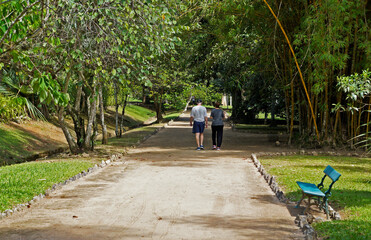 Elderly couple walking on trail in public park, Rio de Janeiro