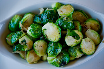 Brussels sprouts shaved and served with crispy bacon and seasoned with olive oil and seasoned with salt and pepper and fresh herbs. Classic American Restaurant appetizer favorite. 