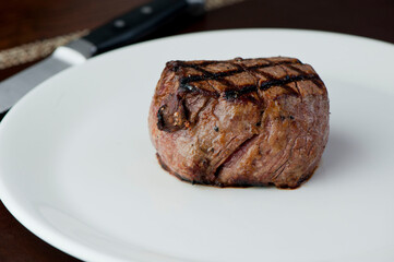 Steak and potatoes. Grade A grass fed angus beef steaks. Tenderloin, filet mignon, New York strip, bone in rib-eye grilled medium rare on outdoor wood-fired grill. Classic American steakhouse entree.