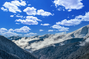 Obraz premium Stunning view of Fagaras mountains in winter. The ridge of the mountain full of snow. There are one of the beautiful road in the world, Transfagarasan