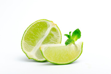 Lime wedge and half of lime, organic green mint on the white background