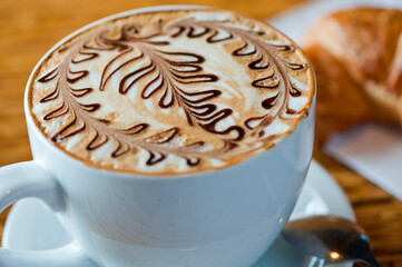Cappuccino. Fresh cup of dark French roast shot of espresso w/ steamed milk. Classic American. French bistro, coffee house or café beverage. Typical drink served at breakfast. white background