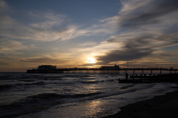 Dramatic sunset over the pier on Worthing seafront.