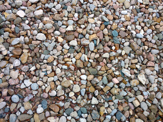 colorful beach pebbles stone rocks path overhead view with deep shadows and bright details as backdrop background for website architecture presentation scenery