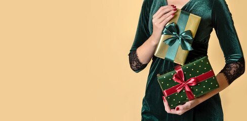 Hands of woman holding Christmas Gifts. Christmas giftboxes with tidewater green ribbon.