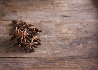 Anise stars on a wooden background witn copy space