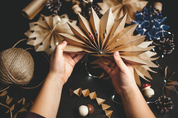 Christmas stars from brown paper. Eco-friendly Christmas decoration. Handmade, needlework, holiday concept.