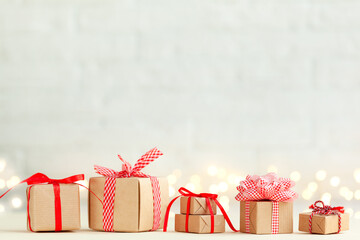 Many different Handmade zero waste Christmas gift boxes with red ribbons. New Year concept.