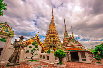Fototapeta premium background of important religious attractions in Bangkok (Wat Phra Chetuphon (Wat Pho - reclining Buddha), a large pagoda and beautiful sculptural art give future generations to explore its history
