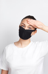 Young woman wearing a mask checking body temperature