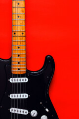 Obraz premium Detail of Electric Guitar on a red background.