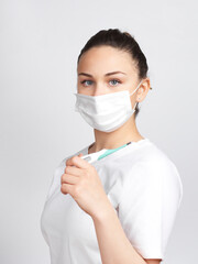 Woman with mask measuring body temperature