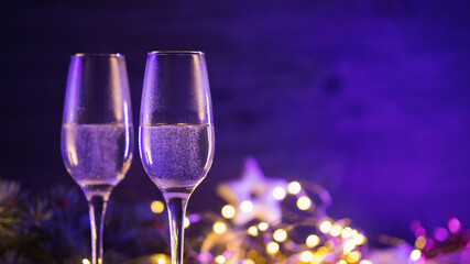 Two glasses of champagne on a Christmas background with copy space. selective focus