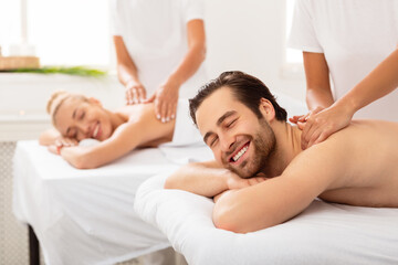 Husband And Wife Enjoying Relaxing Couples Massage At Spa Salon