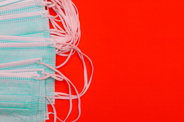 Medical face mask on colored background with copy space. Safety during a pandemic. Respirator to protect against coronavirus. Medicine and healthcare concept